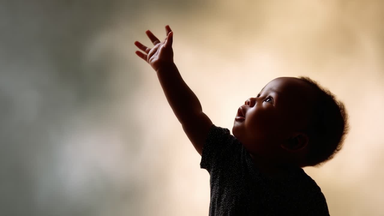 A Curious Infant Reaches for the Sky, Embodying Innocence and Wonder Against a Softly Blurred Background That Evokes Feelings of Hope and Joy