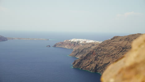 steep cliffs drop into the mediterranean sea on the island of santorini, greece