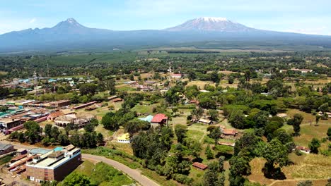 aerial drone view open air market in the loitokitok town, kenya and mount kilimanjaro- rural village of kenya