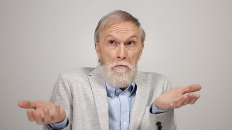 Upset-man-looking-to-camera-in-studio.-Confused-gentleman-moving-eyes-indoors.