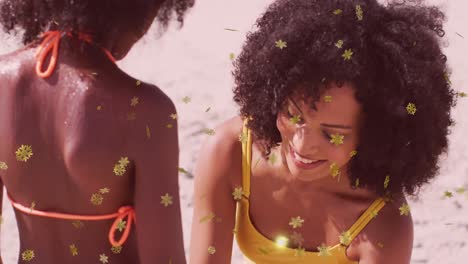 animación de la nieve navideña cayendo sobre una mujer biracial con su hija en la playa.