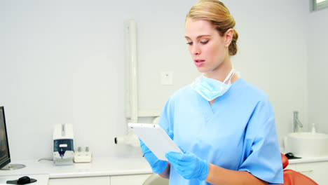 smiling nurse using digital tablet