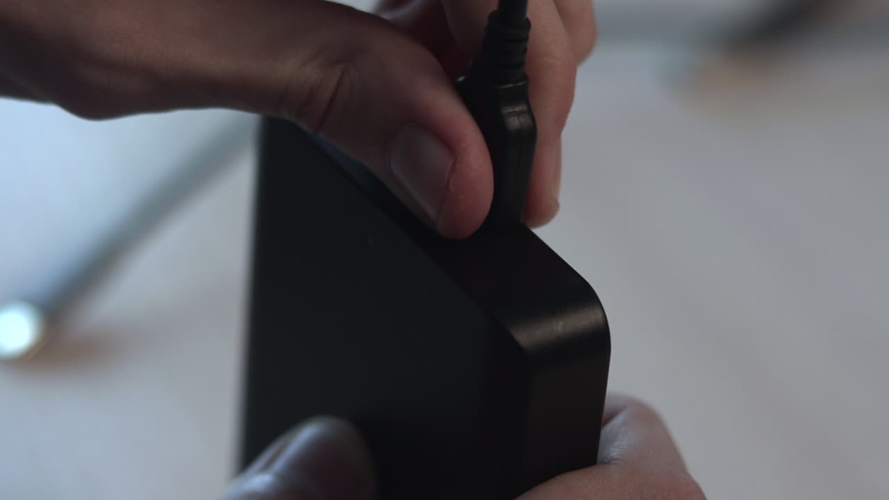 Plugging Power Adapter Into Black Hub Closeup Of Hands Connecting Power Cable To Compact Charger Block