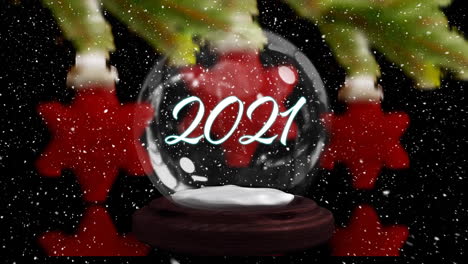 animation of snow globe with 2021 and shooting star over snow falling