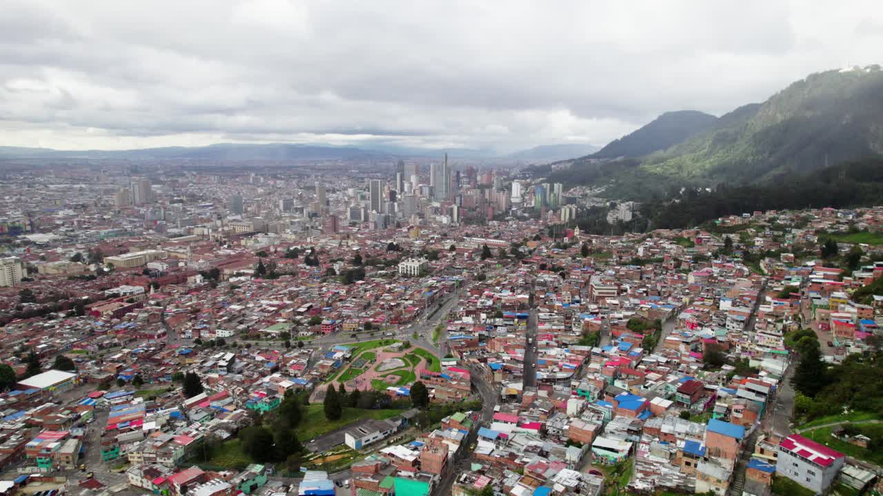 Establishing Aerial Wide Angle of the City Skyline of Bogota, Colourful Homes and Mountain Range