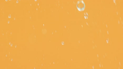 Animation-of-bubbles-moving-on-orange-background-with-copy-space