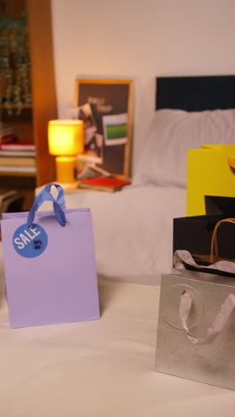 shopping bags on a bed