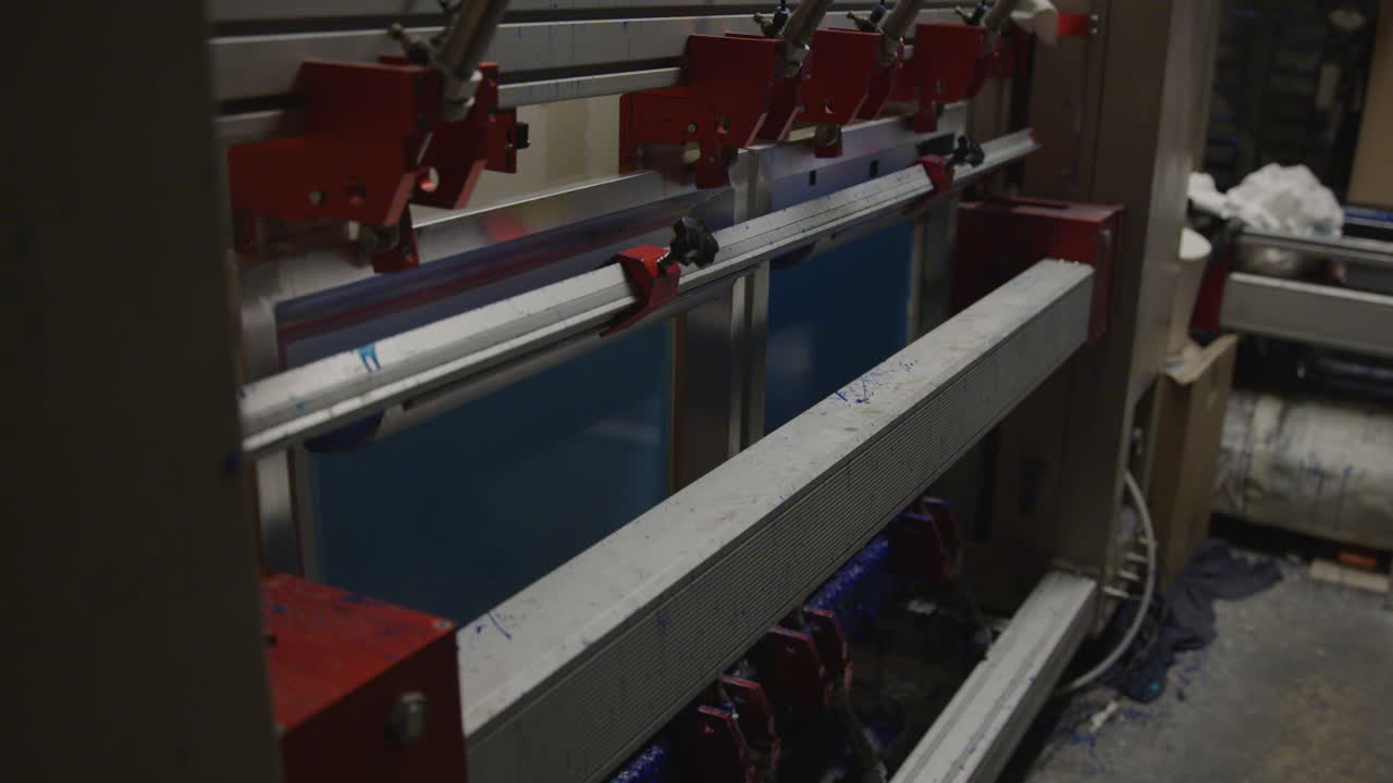 Screen printer repositions frames, preparing for next color layer in design