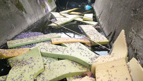 foam mattresses in pieces floating on a canal in bar montenegro