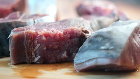 raw tuna steaks on a cutting board