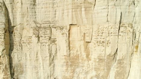 white cliff face with vertical layers