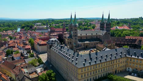 4k aerial drone video of the historic neue residenz palace and bamberg cathedral in the old town area of downtown bamberg, germany (high speed)