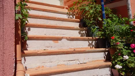 a set of old stone stairs leading to a house