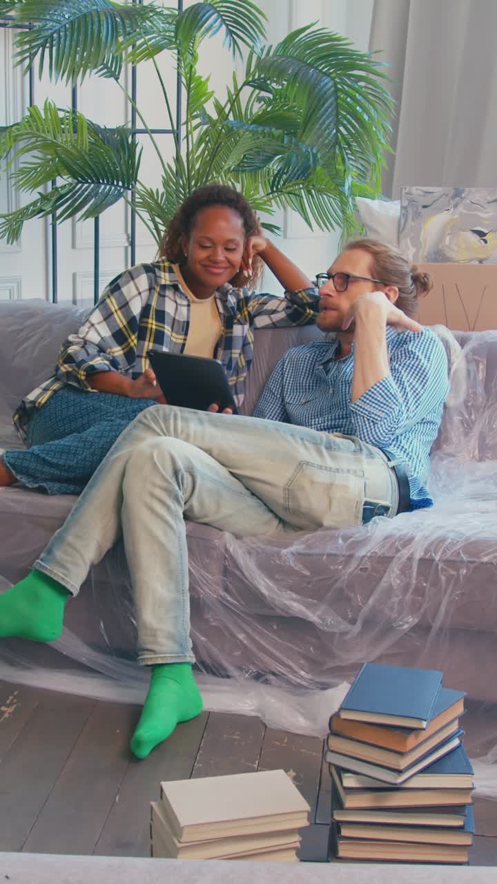 Couple moving into their new apartment and planning their space