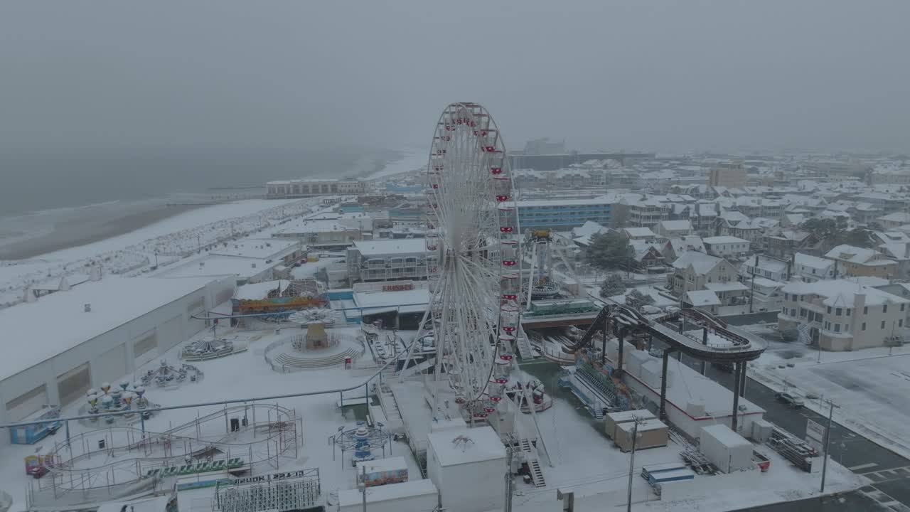 Ocean City Beach Ferris wheel in New Jersey during a snowstorm. Aerial View.