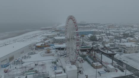 ocean city beach ferris wheel in new jersey during a snowstorm. aerial view.