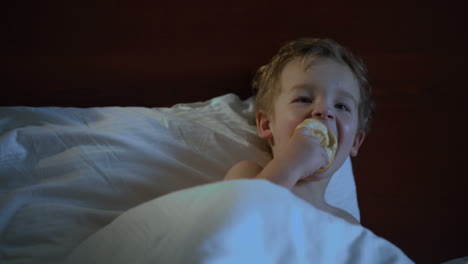 boy eating in bed