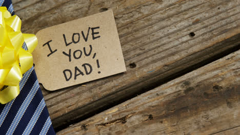 Decorated-tie-with-happy-fathers-day-card-on-wooden-plank