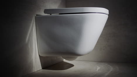 stylish white toilet bowl in a modern toilet. cinematic video. slider 4k shot