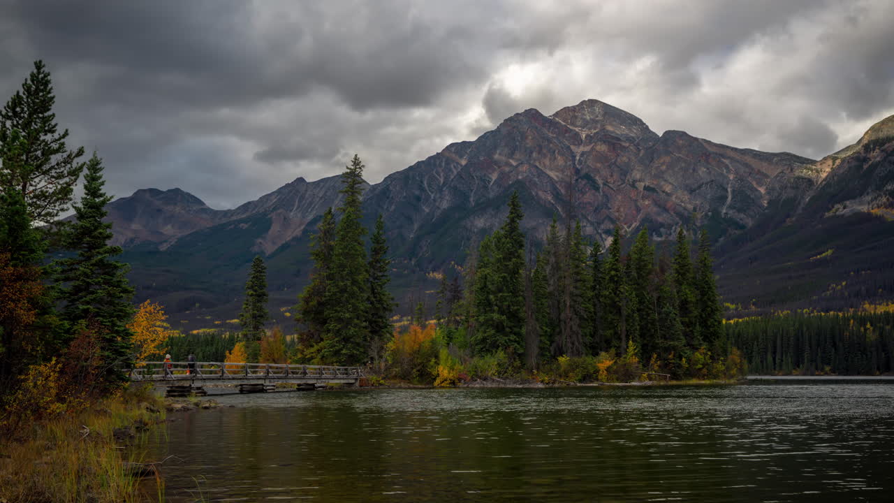Video time-lapse, Isola Pyramid e ponte sul Lago Pyramid, nuvole scure e minacciose in movimento sopra le cime del Parco Nazionale di Jasper, Canada.