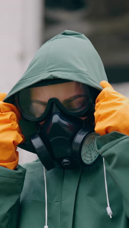 human in mask and hazmat. close up of woman in protective mask. apocalypsis city. vertical video
