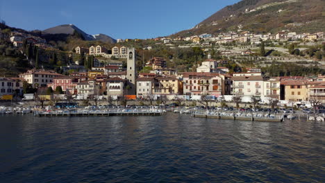 Aerial-drone-sideways-over-Fenaroli-tower-in-Tavernola-Bergamasca-over-Iseo-lake,-Italy