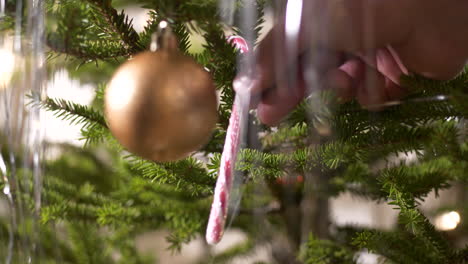 Hand-decorating-christmas-tree,-Close-up