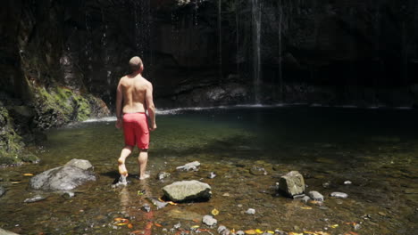 Man-walking-towards-Levada-das-25-Fontes-in-Madeira-Portugal,-slow-motion