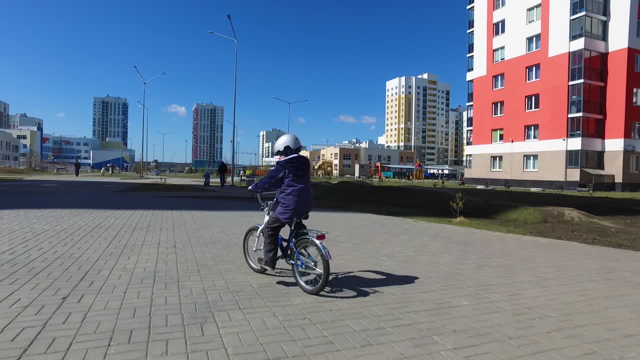 Child riding bicycle in urban park