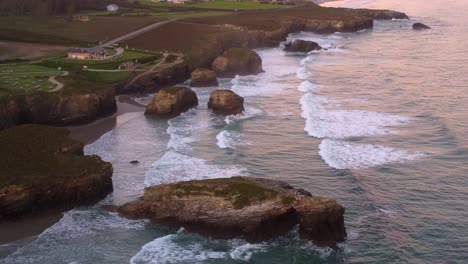 praia das catedrais is on the northwest coast of spain, aerial view at sunset of the arch sculpture rock bound formation over the sandy beach atlantic sea ocean galicia region spain