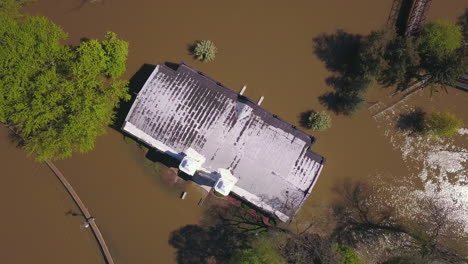 aerial shot of brown flood water around building in ionia, michigan