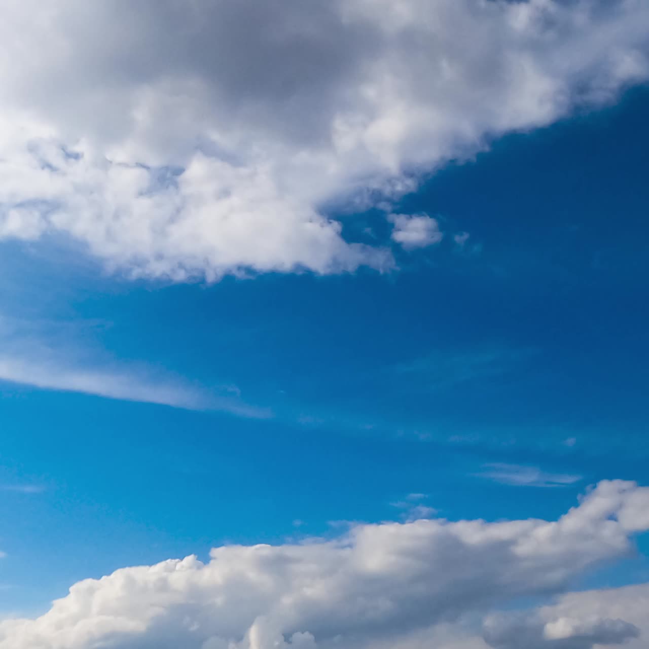 Amazing azure sky with cirro-cumulus white clouds. Light clouds change into heavy grey once. Low angle view. Timelapse