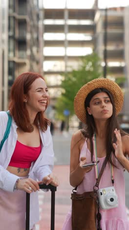 two young women traveling together in the city