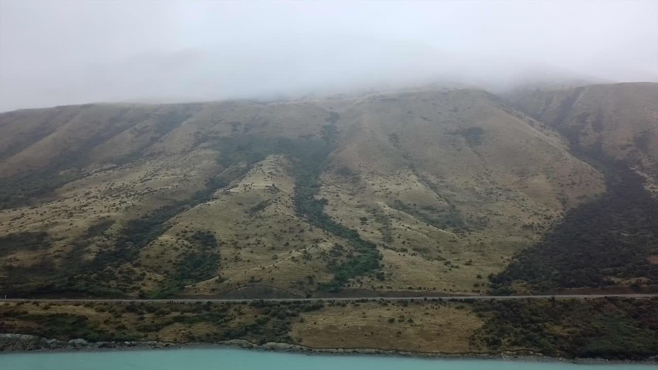 Mountain landscape with lake and fog