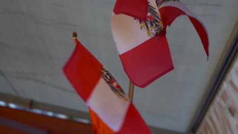 slow motion of two small austrian flags waving in front of souvenir shop