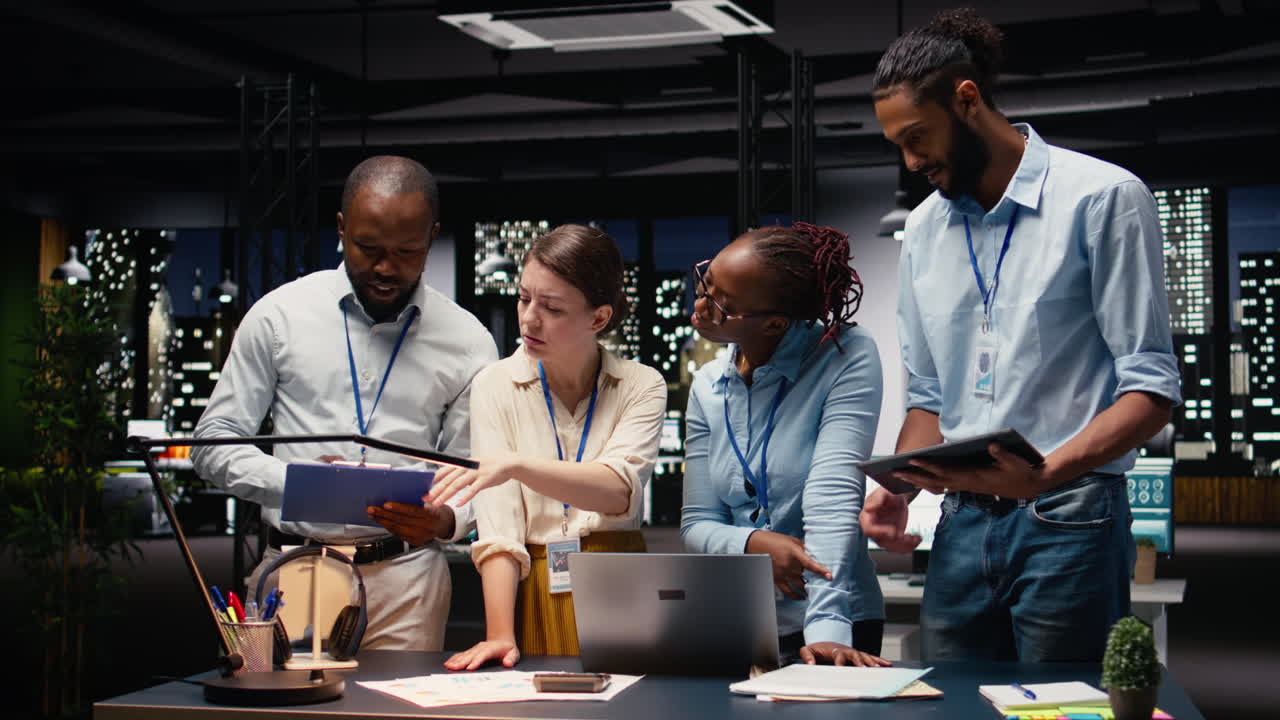 Portrait of colleagues engaged in teamwork during late night briefing session