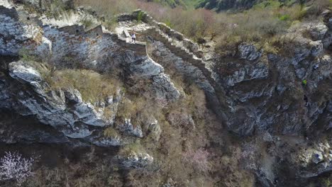 Blonde-Touristin-Steht-Auf-Der-Chinesischen-Mauer,-Während-Weitere-Steile-Hänge-Erklimmen