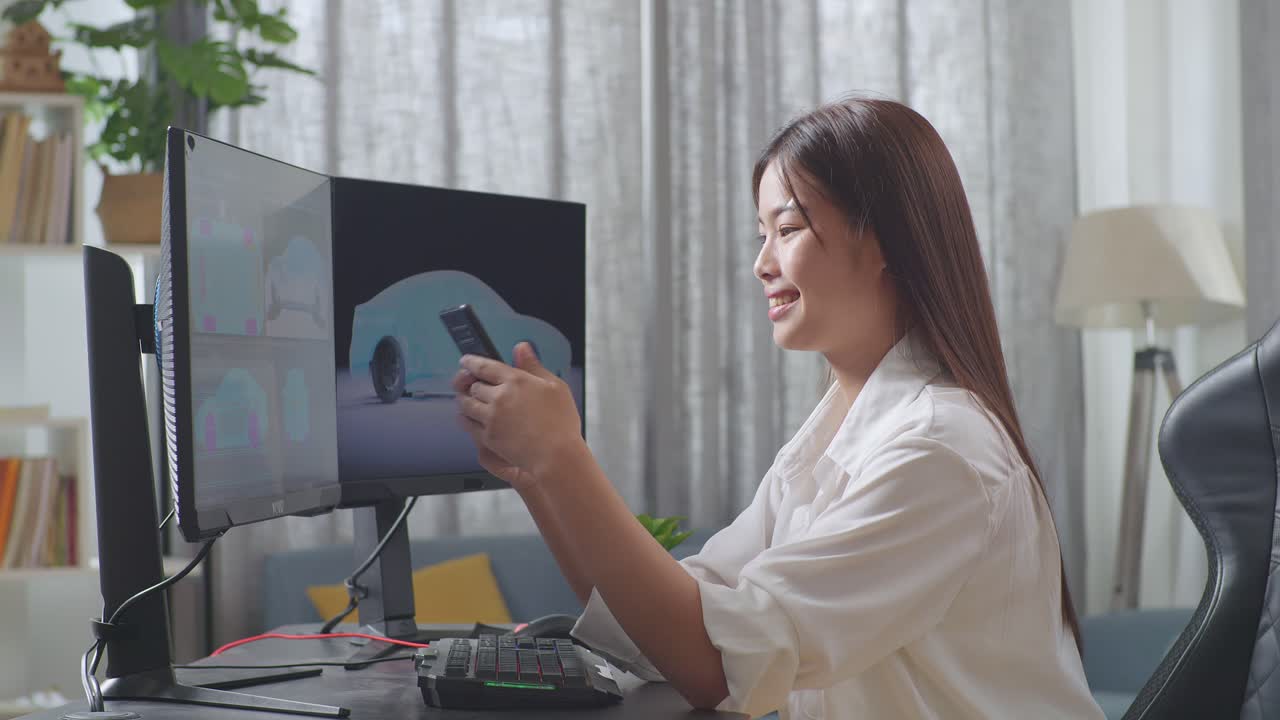 Side View Of Asian Female Automotive Designer Looking At Her Smartphone Then Celebrating The Success While Working On 3D Model Of Ev Car On The Desktop Computers In The Studio