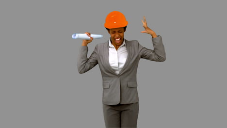 happy architect raising arms on grey screen