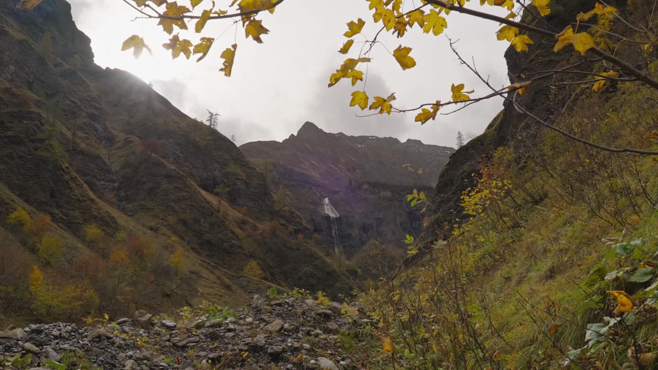 Distant Batoni waterfall in rocky untouched valley on cloudy day
