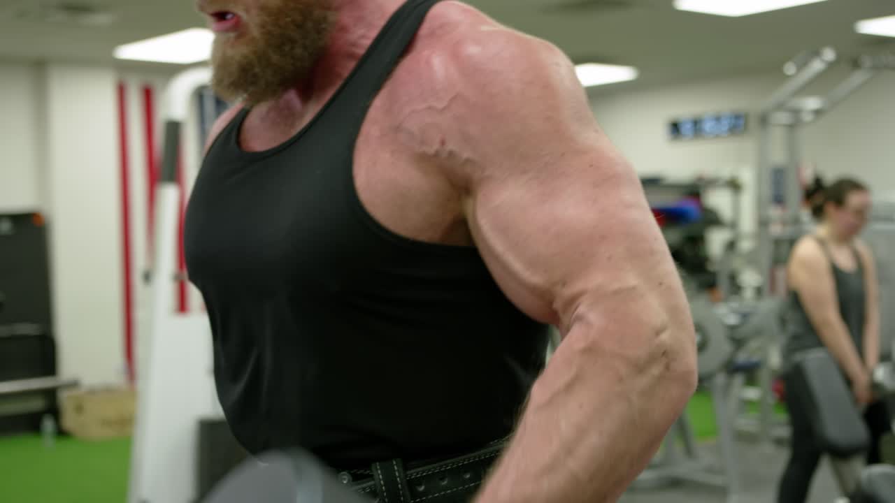 Strong bodybuilder strength workout in sport club