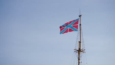 old flag on a wooden mast