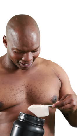 smiling muscular man holding protein