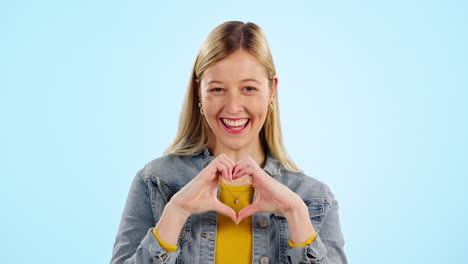 heart, hands and face of happy woman in studio