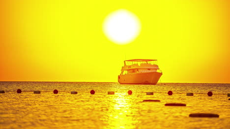 a beautiful timelapse of the sun with a yacht in the foreground