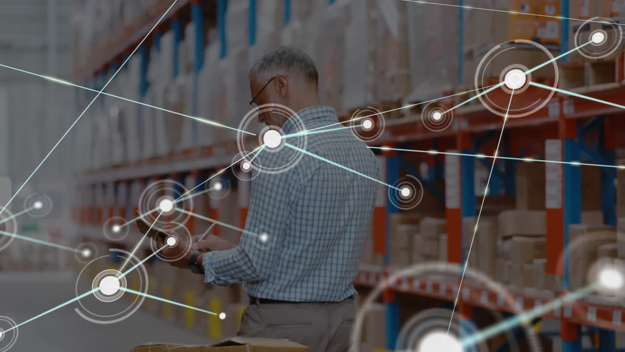 Network of connections against senior male supervisor with clipboard checking stock at warehouse