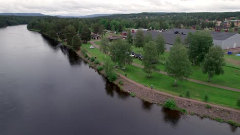 people running along river, running sport, aerial tracking shot