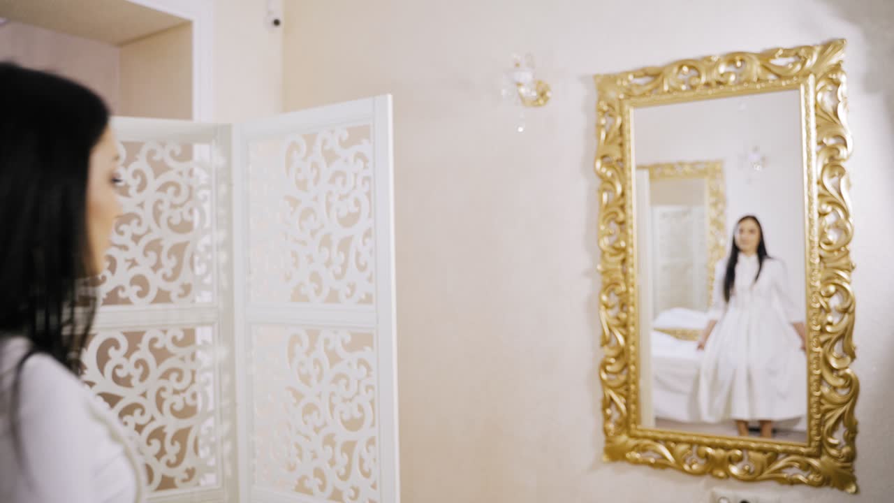 Woman trying dress at showroom. Woman checking elegant dress in mirror reflection
