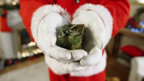 Close-up-of-santa-claus-holding-a-gift-box