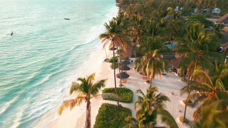 Sunset-over-a-lush-beachfront-with-swaying-palm-trees-and-thatched-huts